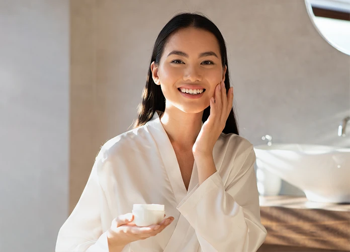 Young Female Applying Moisturizer As Part of Morpheus8 Aftercare Routine